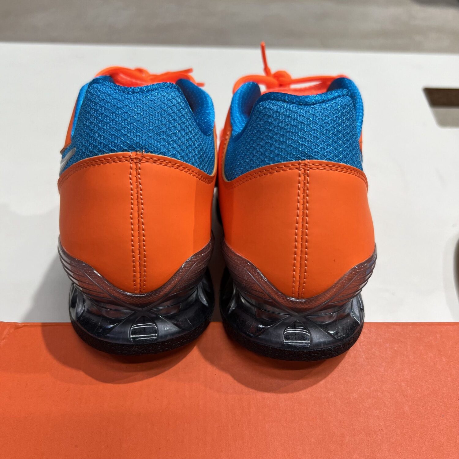 Blue and best sale orange nike shox